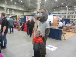 flooring mascot with a boy at a expo exhibit